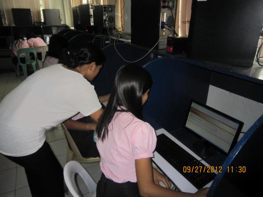 Ms. Galang, the Chief Librarian, assisting CBA students to access Infotrac site...