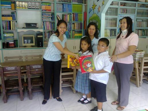 Ms. Galang donating books to Ms. Laggui, pupils and Faculty at Taliptip School Library.